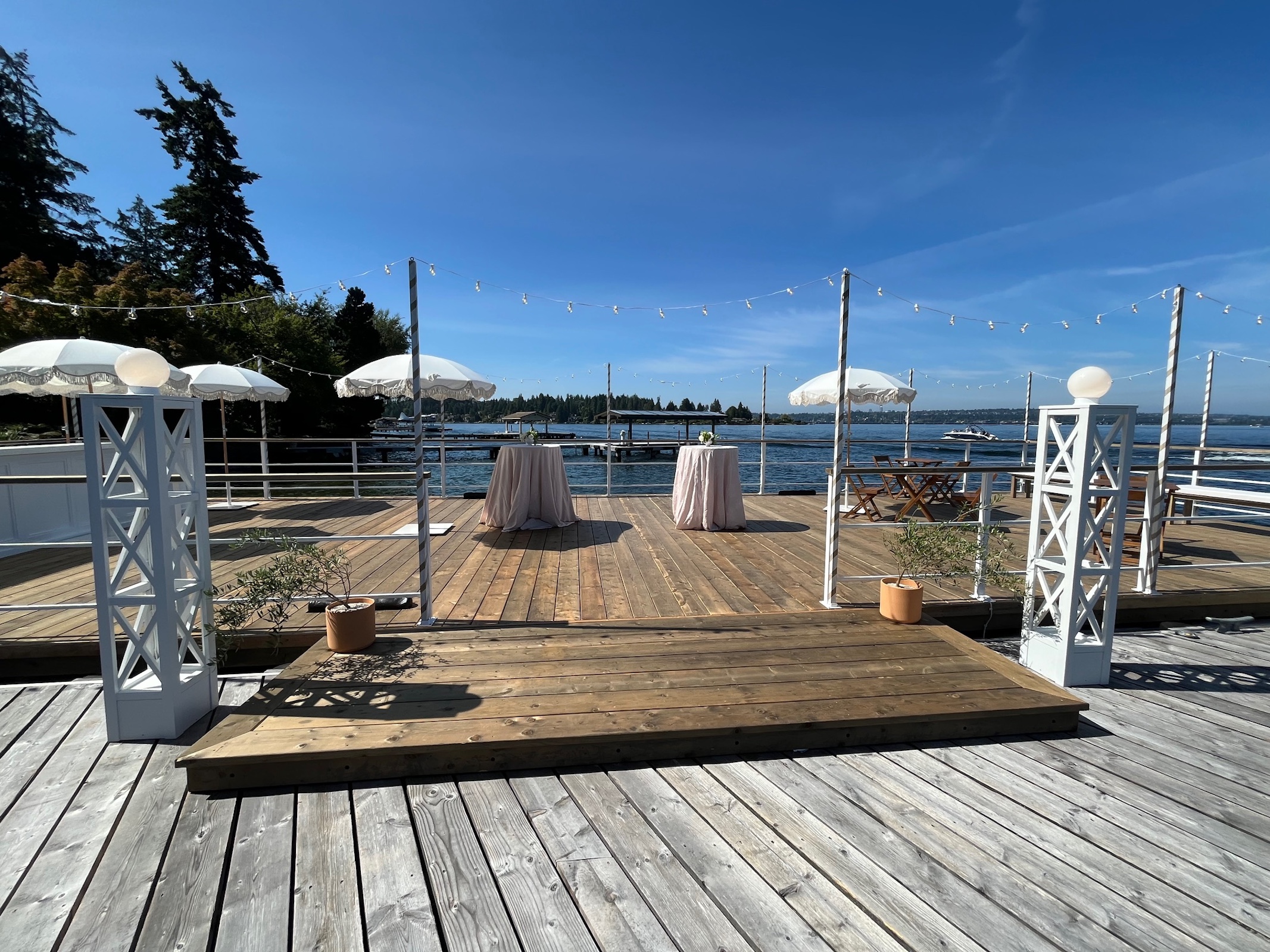Wedding reception setup on a floating event barge with water views and outdoor tables